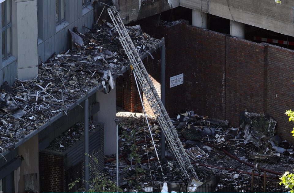  A ladder leans against Grenfell tower among the rubble