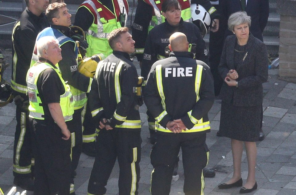  Theresa May talked to firefighters at the site of the Grenfell Tower fire