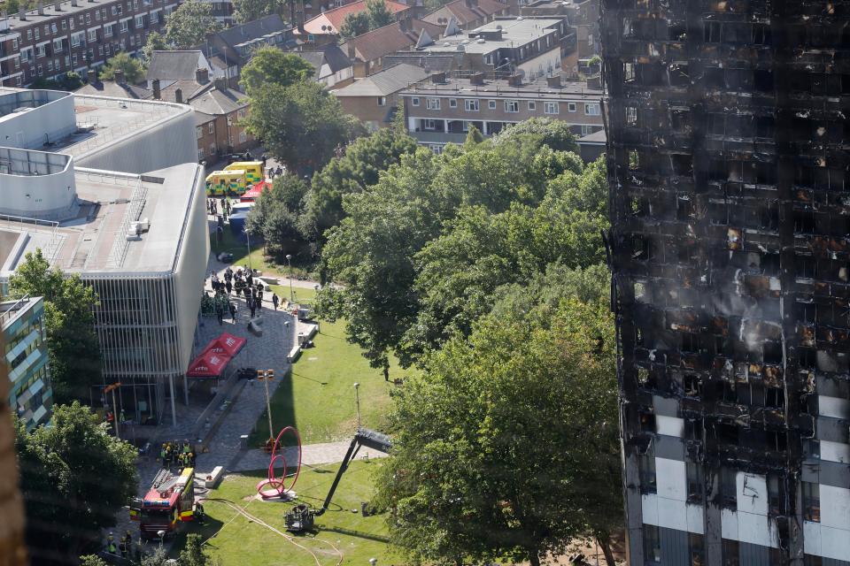  Mrs May is pictured talking to emergency services next to the building on the left of this picture