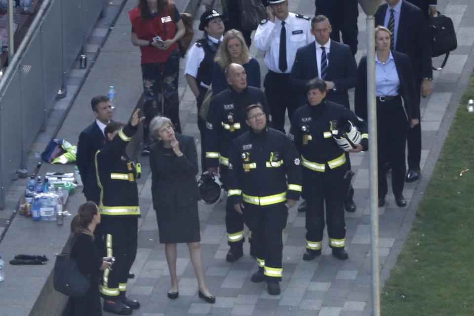  Theresa May only spoke to emergency workers while visiting the site of the Grenfell tower fire