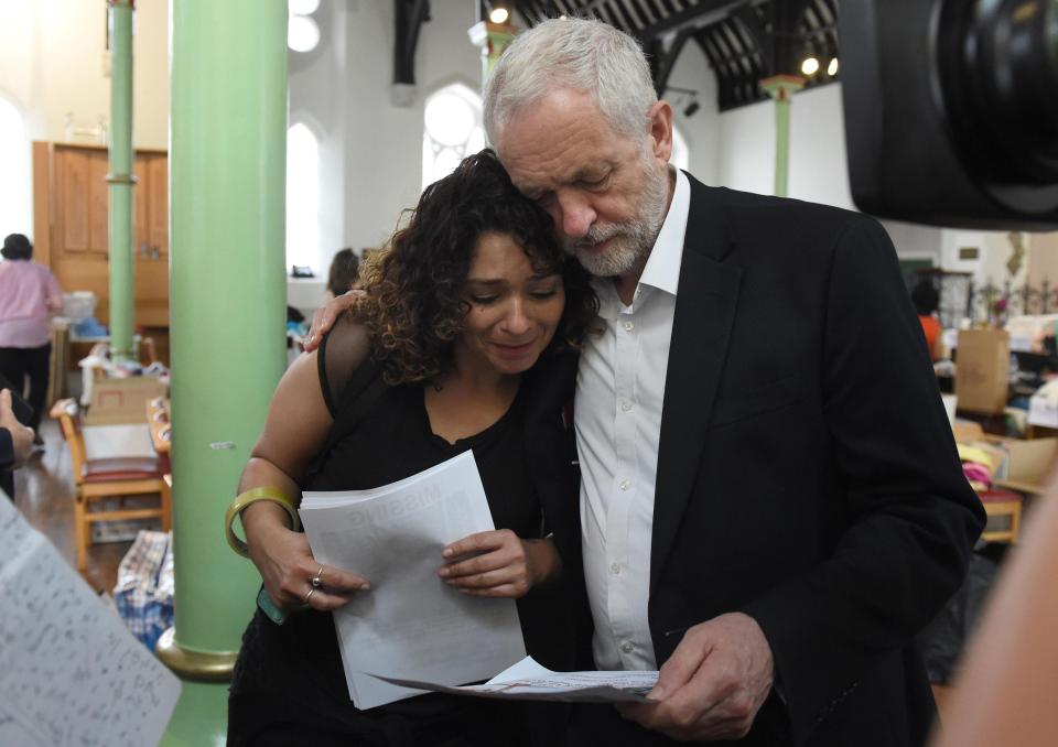  Mr Corbyn comforts a local resident during his visit to the scene