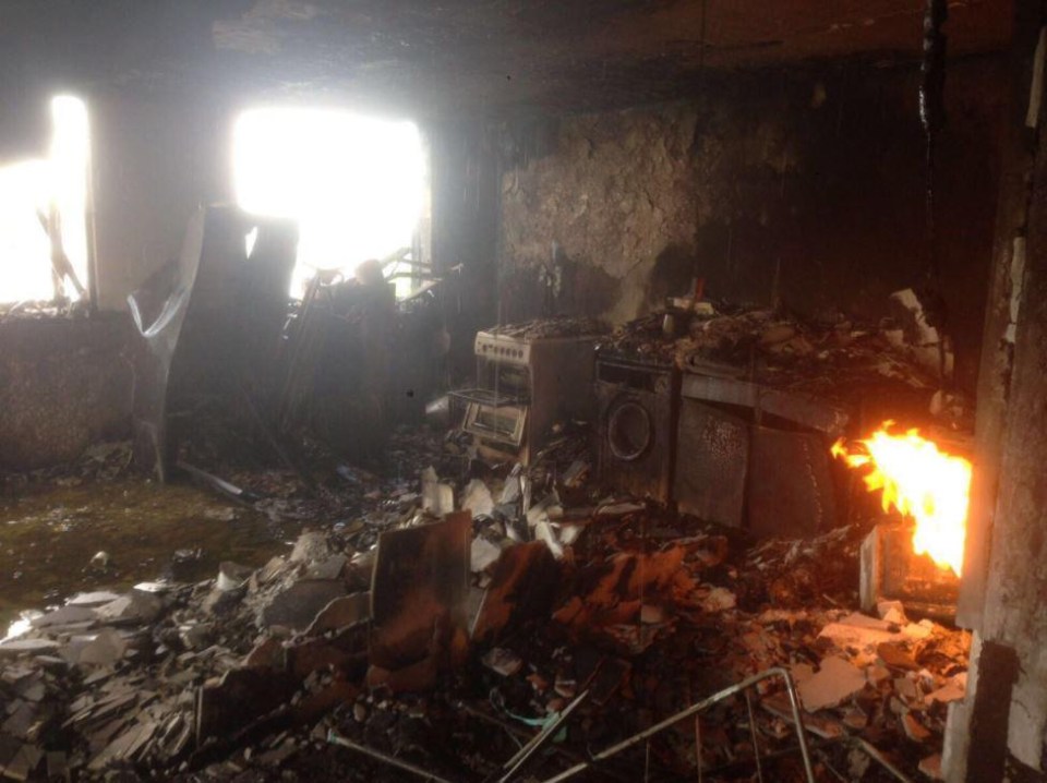 Harrowing photos from the morning of the blaze shows the charred remains of a kitchen as a fire still burns in the corner