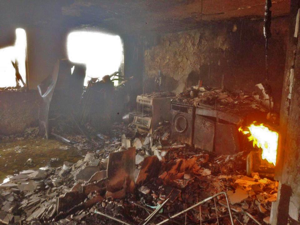  Harrowing first pictures from inside one of the flats in the tragic tower block shows a small fire still burning