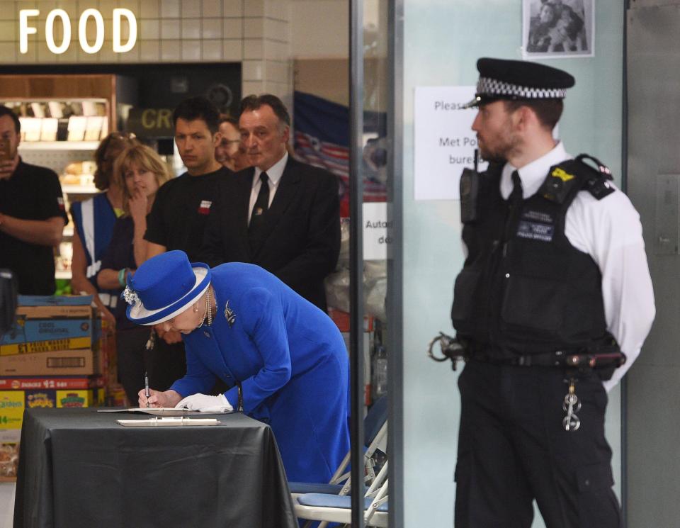  The Queen signs a condolences book close to the site of Grenfell Tower in West London