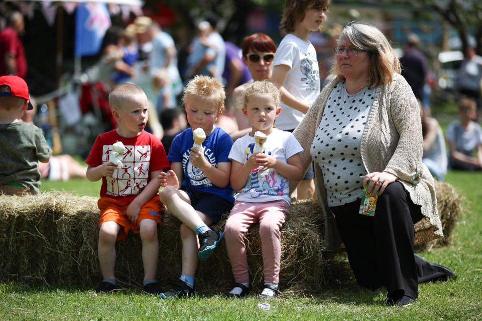  Youngsters tuck into ice creams at The Great Get Together in Heckmondwike, in West Yorkshire