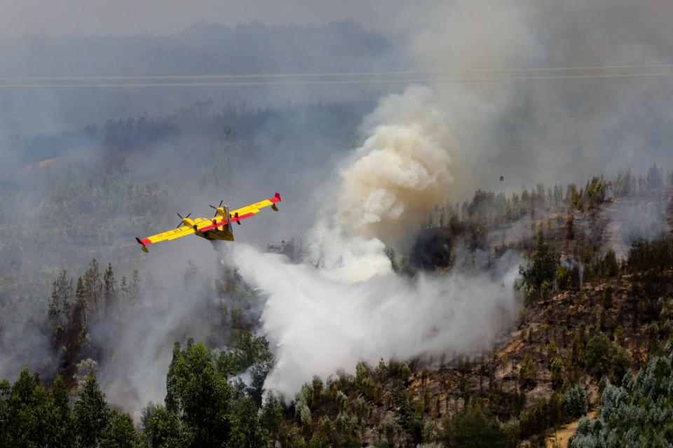  Spanish Canadair fire fighting aircraft drops water over the Pedrogao Grande forest fire