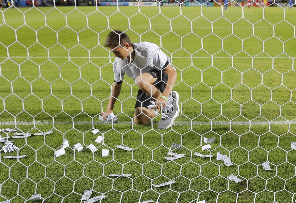  Helpers then ran onto the pitch to remove the bank notes so the game could continue