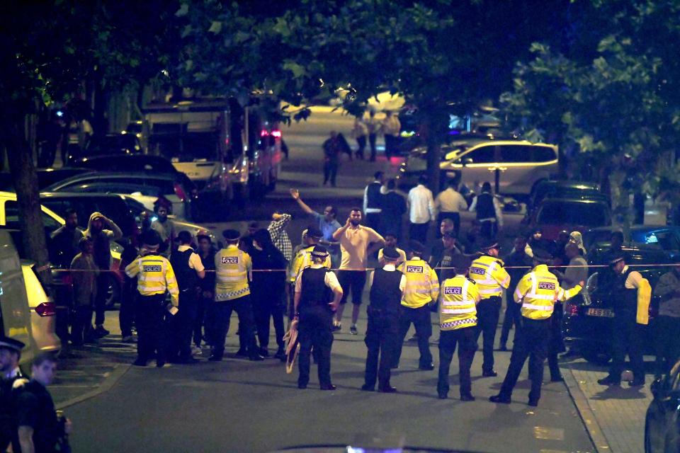  Police stand at the cordon after the road was closed to traffic amid the chaos last night