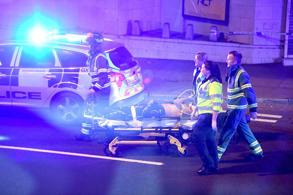  Ambulance crews take an injured victim away from the scene