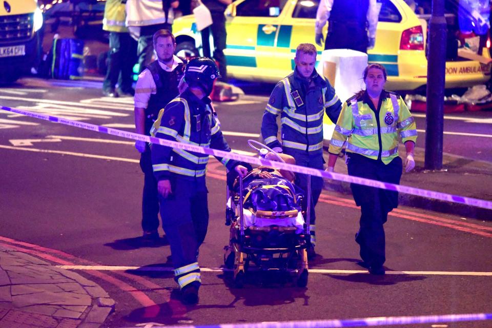  A wounded person can be seen being taken away from the horror scenes on a stretcher