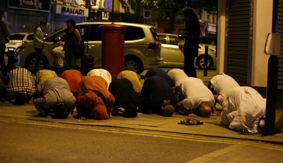  Muslims pray near the scene of the attack last night