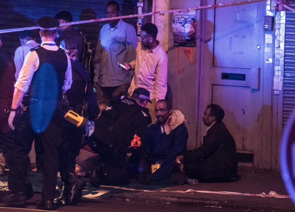  An injured man is tended to by police after the van crashed into a group of people in Seven Sisters Road