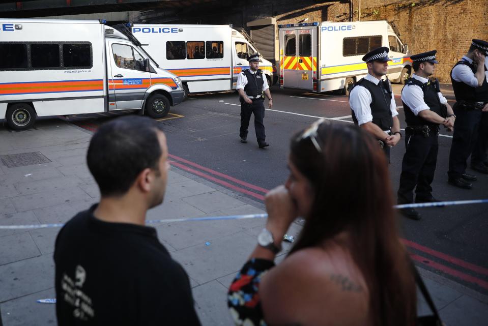  Onlookers near the police cordon this morning where investigations into the horror attack continue