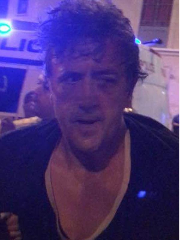  The suspect with a battered bruised face after being wrestled to the ground by witnesses