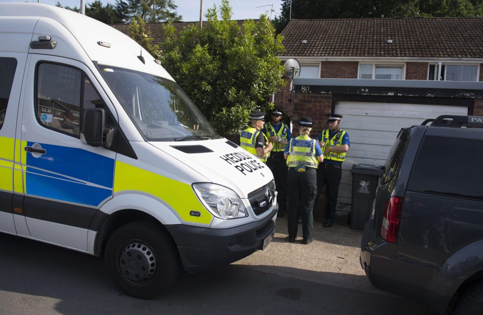  Police officers stand outside a property during a search of a house on Glyn Rhosyn, Pentwyn, which is believed to be the home of Darren Osborne