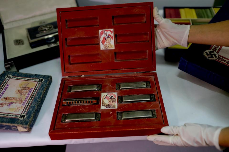  A box with swastikas containing harmonicas for children