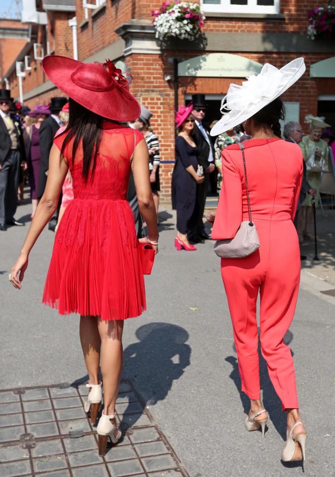  These two pals saw red as they entered Royal Ascot in co-ordinating outfits, one donning a pretty dress while the other opted for a jumpsuit