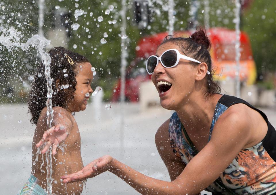  Two-year-old Sofia Elahcene-Mantack and her mother Semia Elahcene cool off in a fountain in Birmingham today