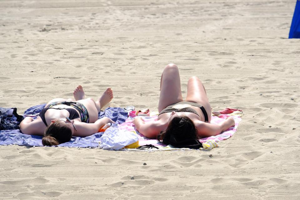  Soaking up the sunshine in Lyme Regis today as the mercury soars towards the 30s for the fourth day in a row