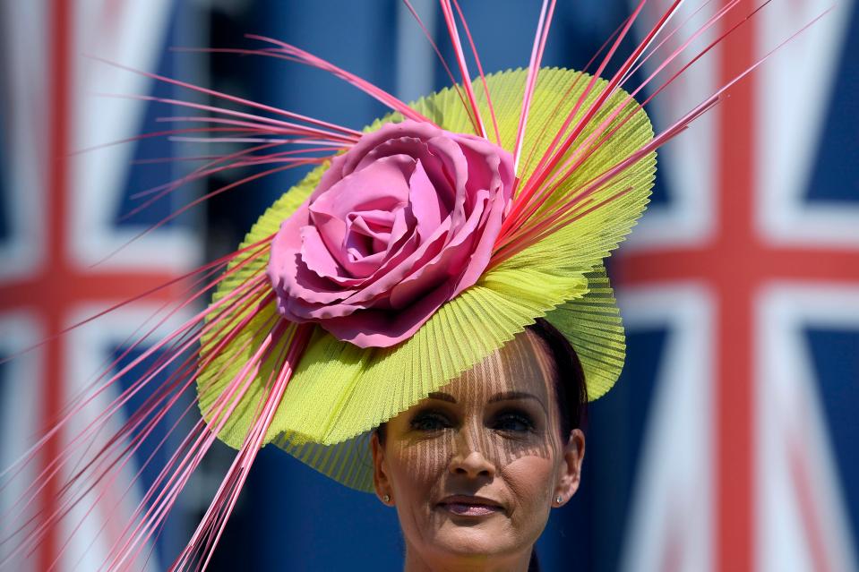  A racegoer was shielded from the beaming sun thanks to her quirky yellow hat, which featured a giant pink rose