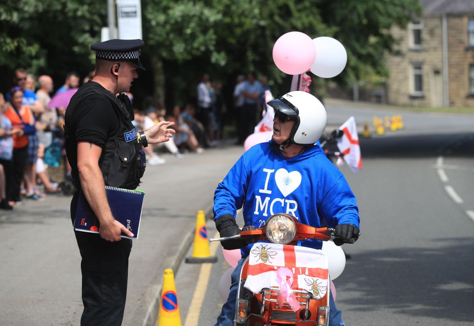 A mourner wearing an ‘I love Manchester’ jumper arrives to pay tribute to Olivia