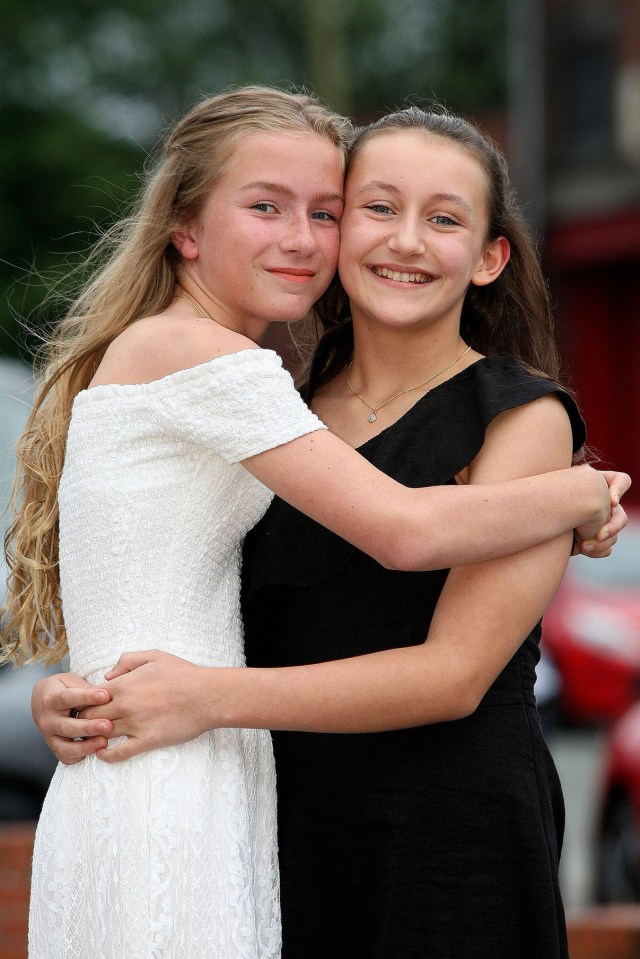 Acacia Seward, aged 11 with pal Olivia Fox, left, at her school prom, where she managed to walk in without her crutches after being injured in the Manchester terror attack