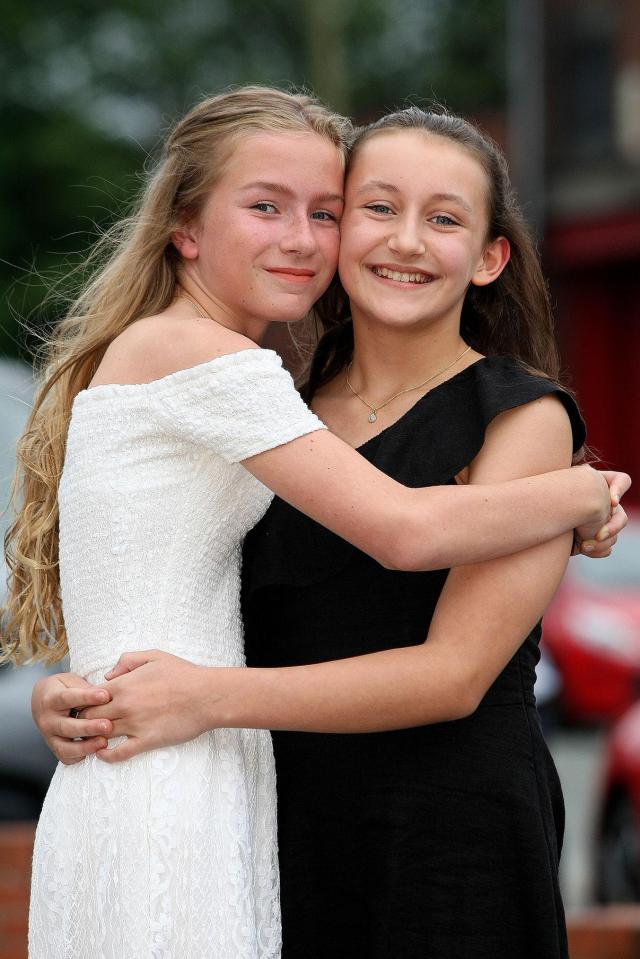  Acacia Seward, aged 11 with pal Olivia Fox, left, at her school prom, where she managed to walk in without her crutches after being injured in the Manchester terror attack