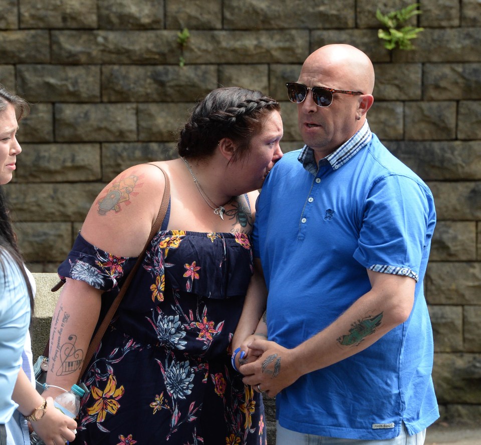 The devastated mum and stepdad of Olivia comfort each other as they attend her funeral today