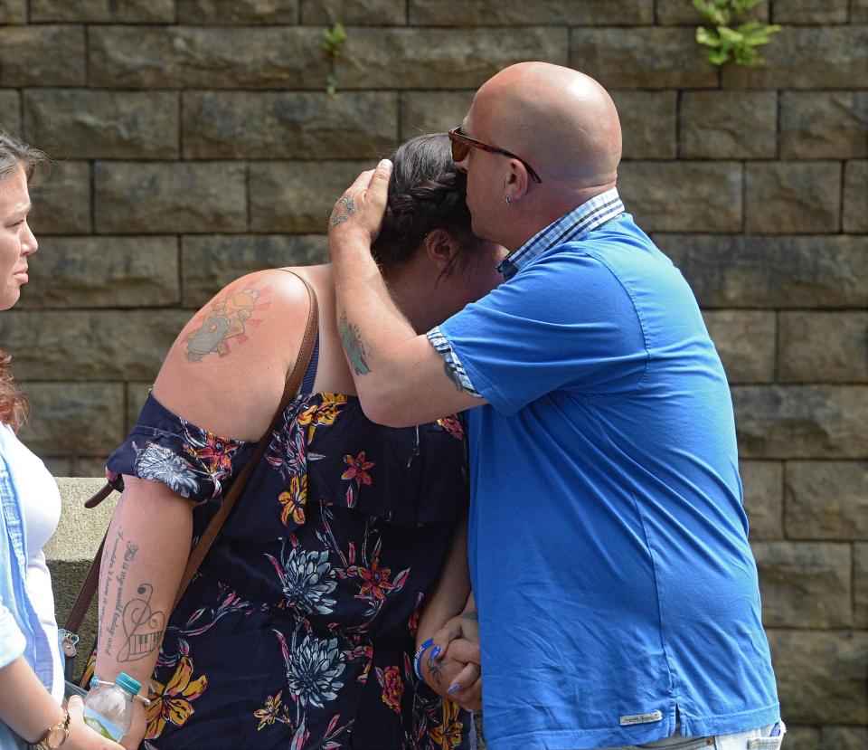  Olivia's stepdad comforts her mum, Charlotte, as they arrives for the funeral of the 15-year-old