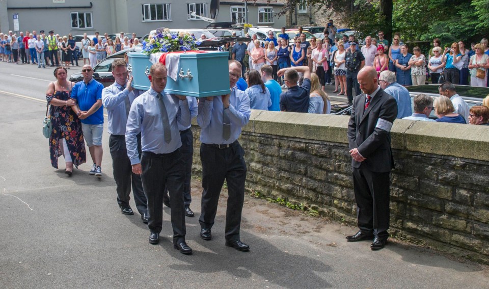 Her mum and stepdad walk behind the coffin as it is carried into the church