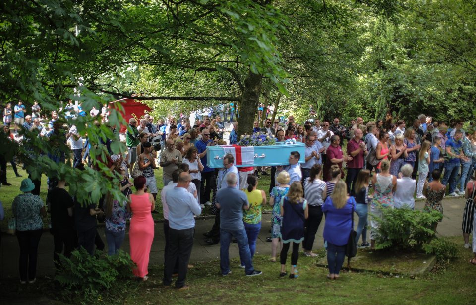  Mourners applause as Olivia's coffin is carried through the crowds