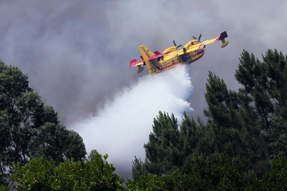  A French Civil Security 'Canadair CL-415' firefighting plane drops water over the blaze