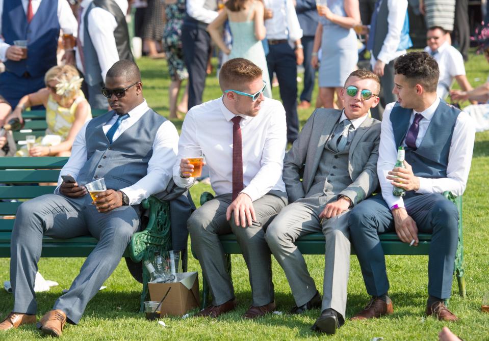  Four male pals took off their suit jackets and were spotted enjoying a pint of beer on a bench in the grounds