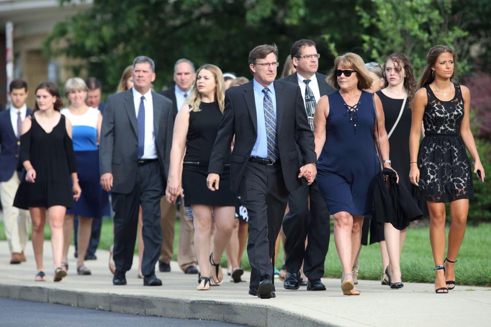  Mourners walk to Wyoming High School to attend the emotional gathering