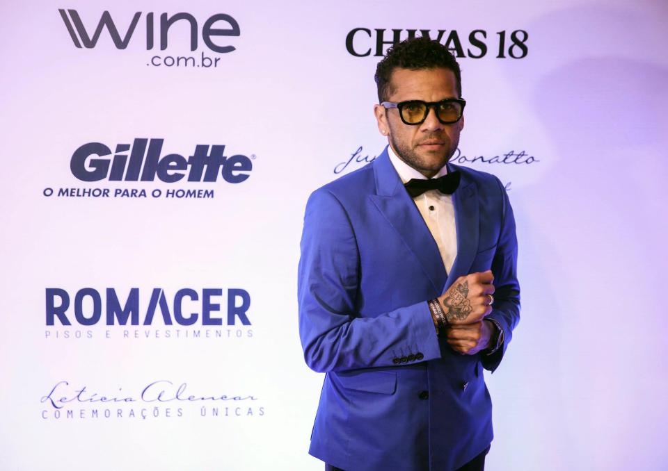  Dani Alves arrived in a blue suit to a charity do hinting he was joining Manchester City