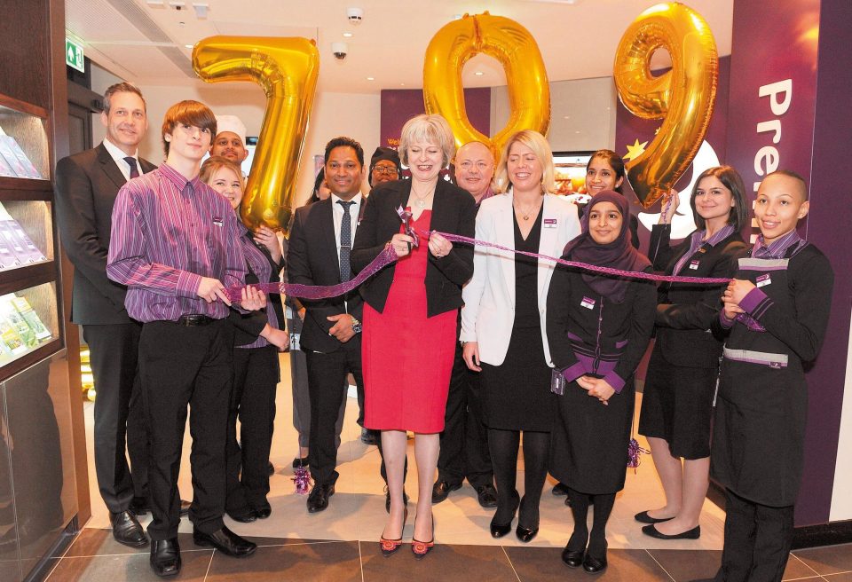  Theresa May cuts the ribbon as she opens a Premier Inn in Maidenhead