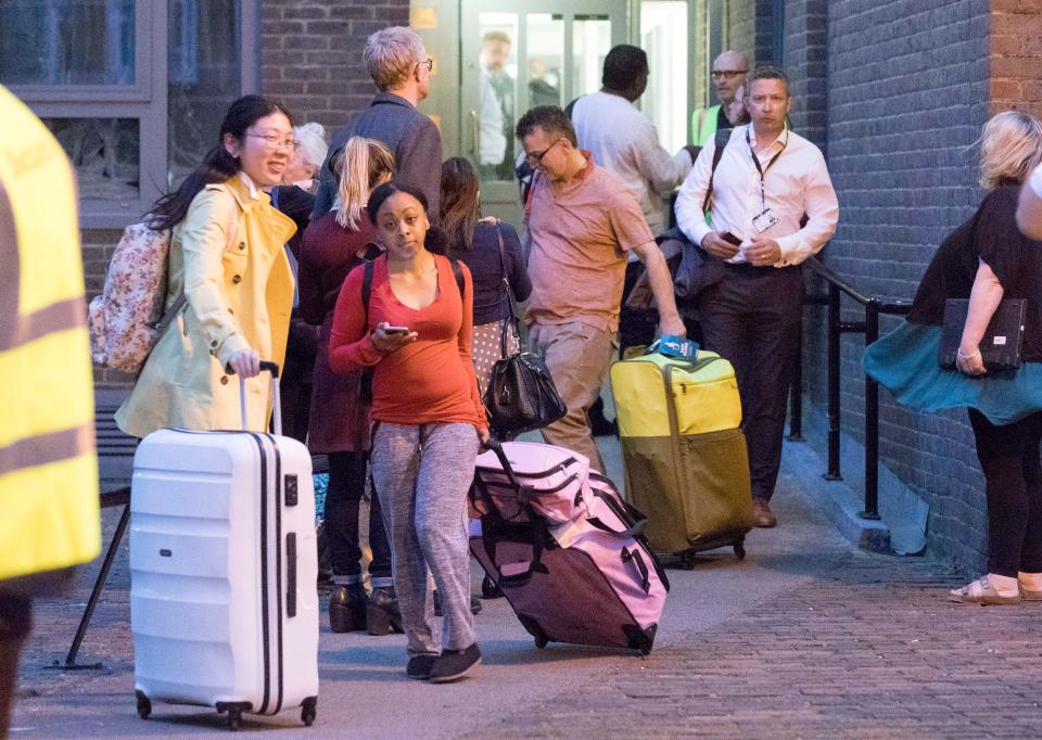  Residents carrying their belongings are evacuated from the tower blocks in Camden tonight