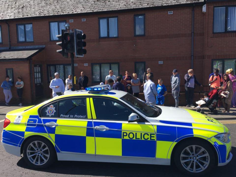  People gathered at the side of the road after the incident unfolded this morning