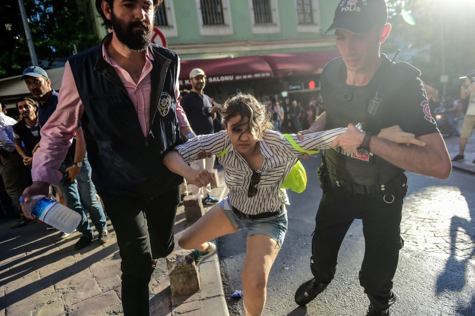 Turkish cops drag away a campaigner for gay rights in Istanbul