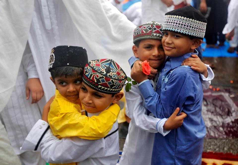  Children greet each other after offering Eid al-Fitr prayers which mark the end of Ramadan in Mumbai, India