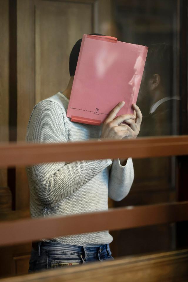  Svetoslav Stoykov hides his face in the dock today as he appears for trial charged with kicking a woman down stairs at a metro station in Berlin