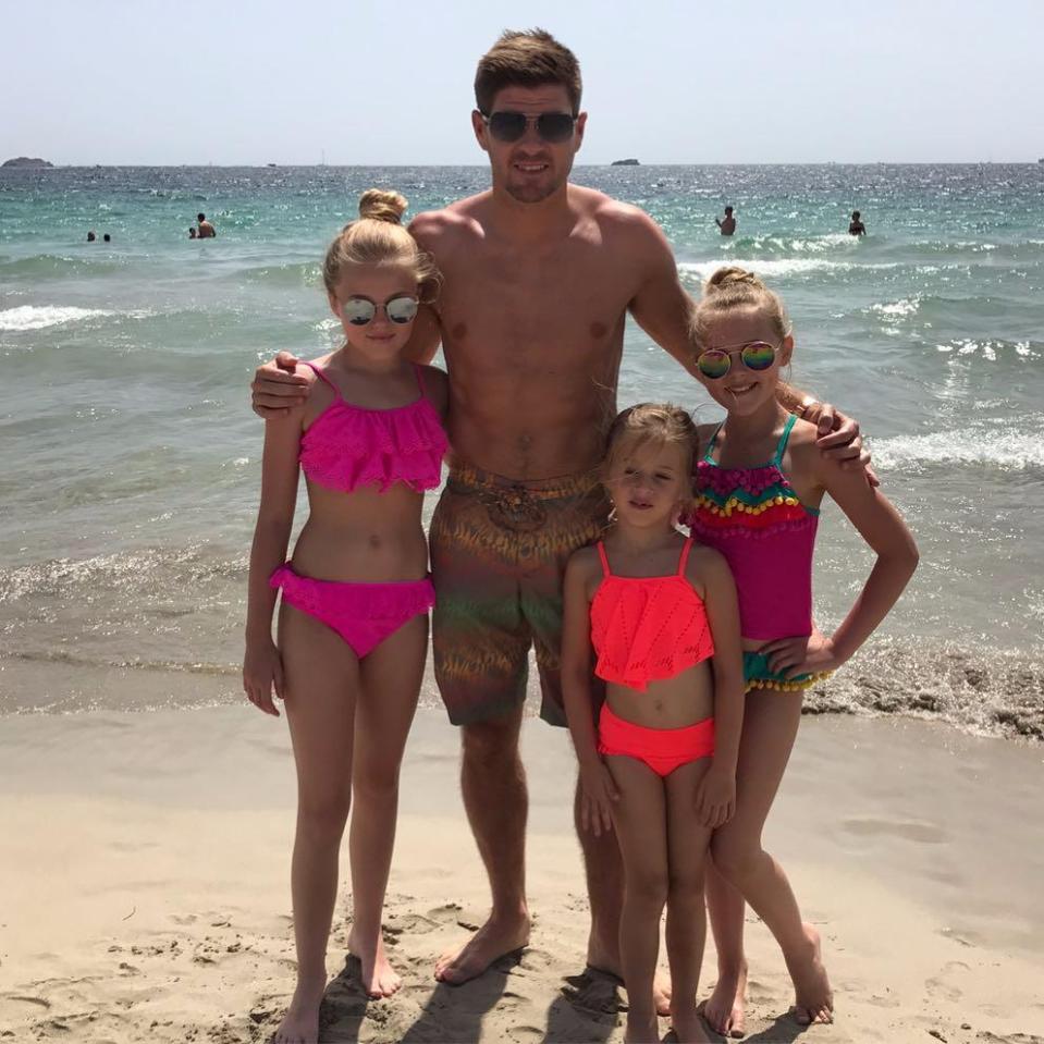  Gerrard shows off his six-pack as he poses for a snap with his three daughters