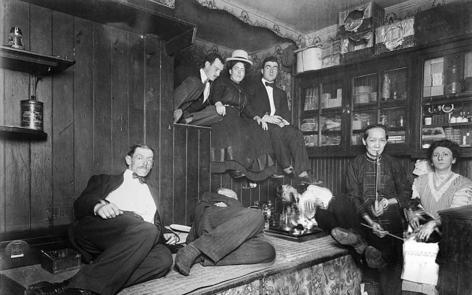  Smartly dressed opium smokers lounge around in an opium den in New York in 1925 as the drug craze swept the country