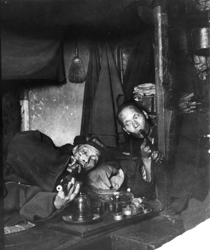  A pair of Chinese men pose for the camera while smoking opium in New York in 1909