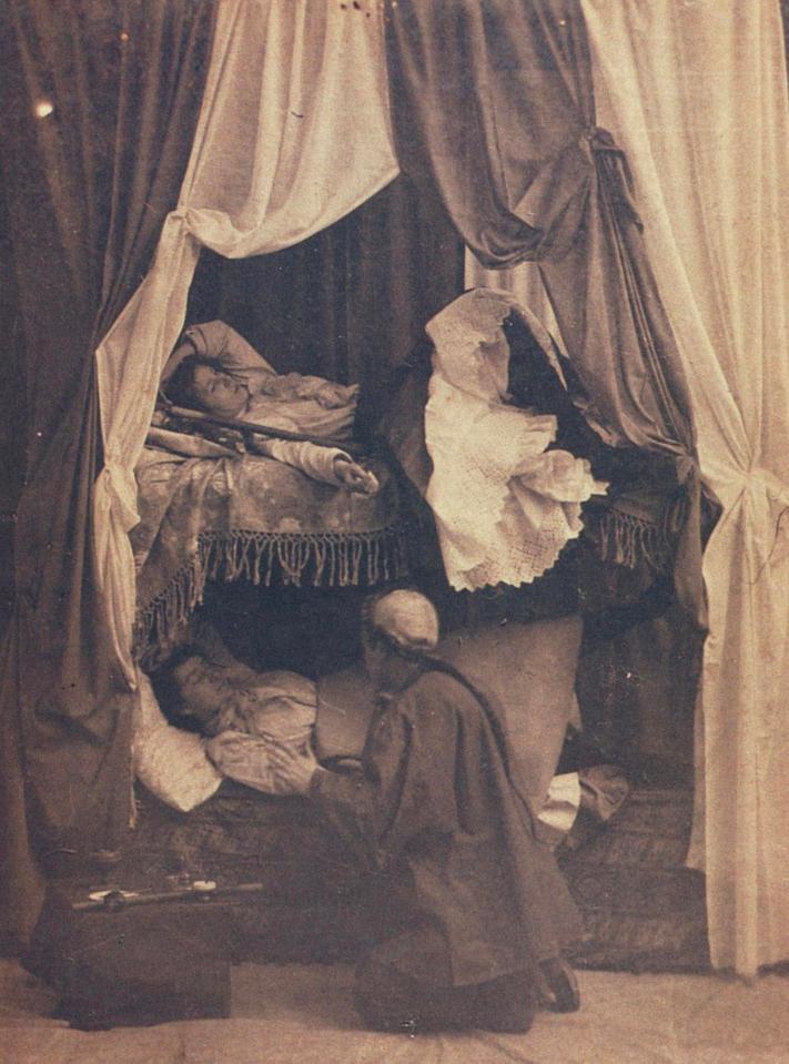  Two women are tended to as they lie in beds in one of the more upmarket dens in New York in around 1899