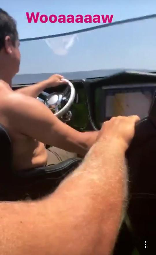  Mesut Ozil sits in the back of a speedboat while being driven through the ocean