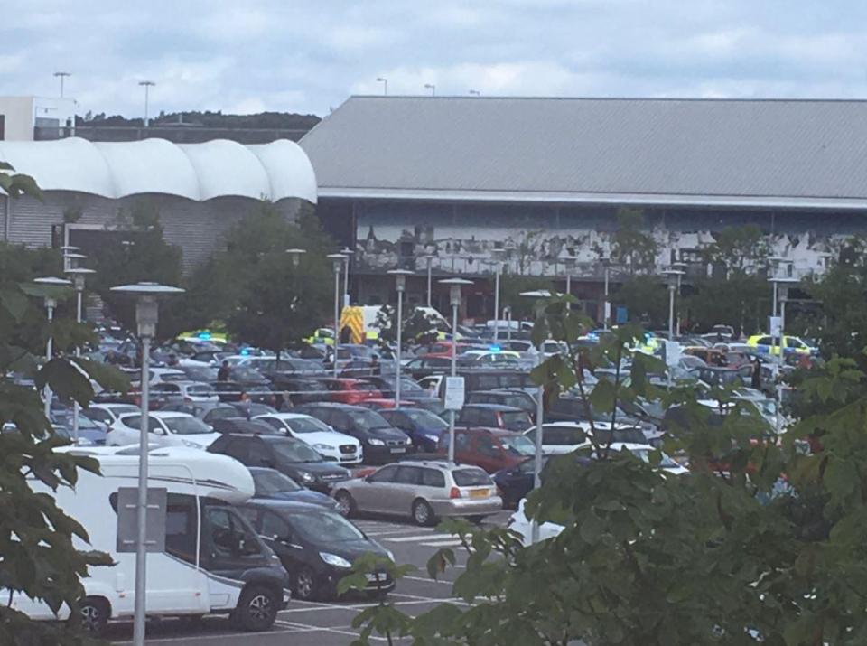  Police cars around the shopping centre, which has been placed on lockdown