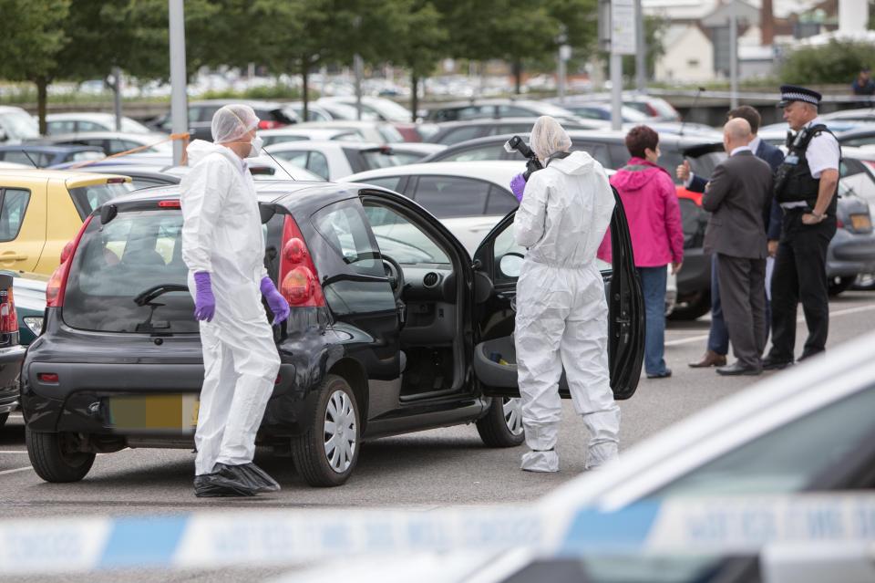  Forensics examine the scene where a woman was killed on Thursday