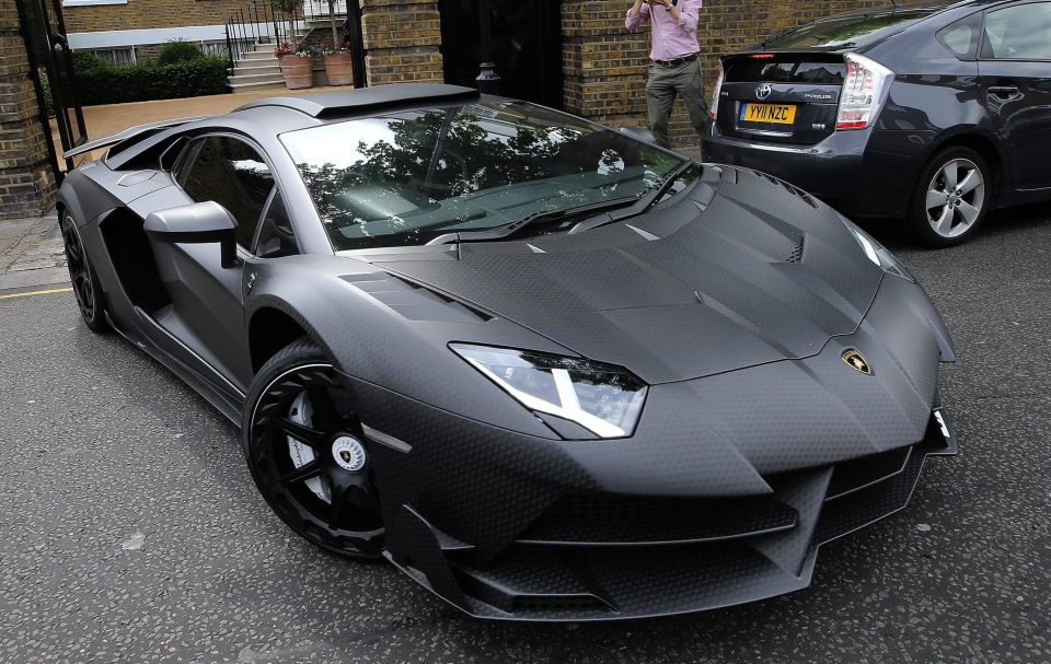  Another jet black Lambo is driven away from the West London mansion today