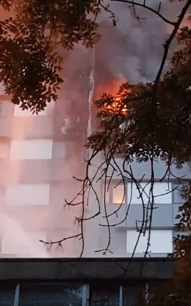  Footage shows firefighters dousing the blaze as crowds cheer in relief